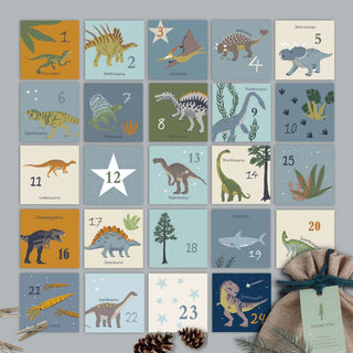 Adventskalender-Set mit 24 Dino-Motiven, nummerierten Boxen, DIY-Dekoration, zum Befüllen, in einem Raster arrangiert.