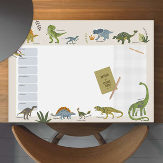 Papierblock Wochenplaner "Dinosaurier" mit bunten Dinosaurier-Illustrationen, täglichen Segmenten, Notizbereich auf Holztisch.