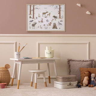 Kinderzimmer mit Kinderschreibtisch , Kinderaccessoires und einem Poster mit Waldtieren an der Wand